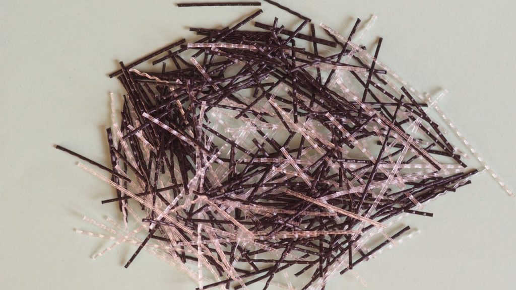 Concrete reinforcing fiber for strength and durability